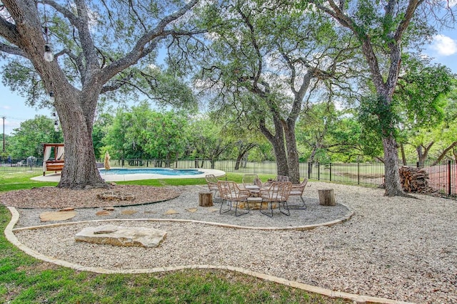 view of yard with a fenced in pool, a fenced backyard, and a patio
