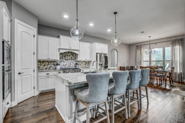 kitchen with recessed lighting, a sink, dark wood-style flooring, and stainless steel appliances