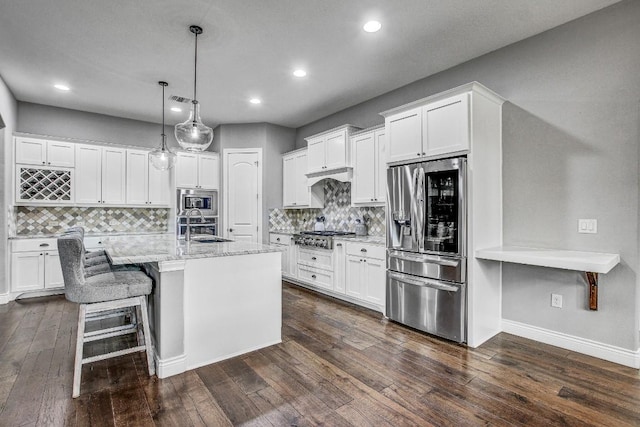 kitchen with recessed lighting, a sink, appliances with stainless steel finishes, and dark wood-style floors