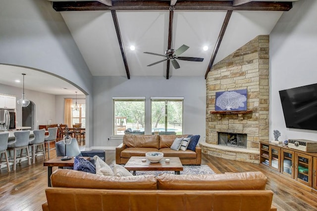 228 Marbella Way, Georgetown, TX 78633 - living area with high vaulted ceiling, wood finished floors, ceiling fan, a fireplace, and arched walkways
