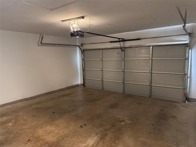 garage with baseboards and a garage door opener