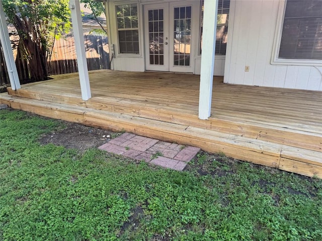 wooden terrace featuring french doors and fence