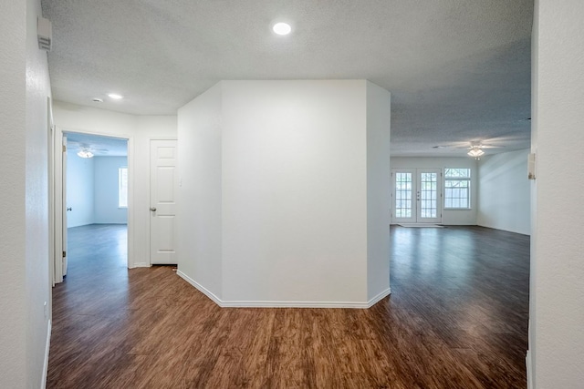 1911 Timberwood Dr, Cedar Park, TX 78613 - hall featuring dark wood finished floors, a textured ceiling, baseboards, and recessed lighting