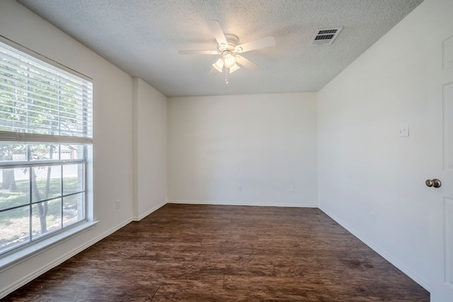 1911 Timberwood Dr, Cedar Park, TX 78613 - empty room featuring plenty of natural light, a ceiling fan, dark wood-style flooring, a textured ceiling, and baseboards