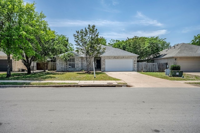 1911 Timberwood Dr, Cedar Park, TX 78613 - view of front of house with driveway, an attached garage, and brick siding