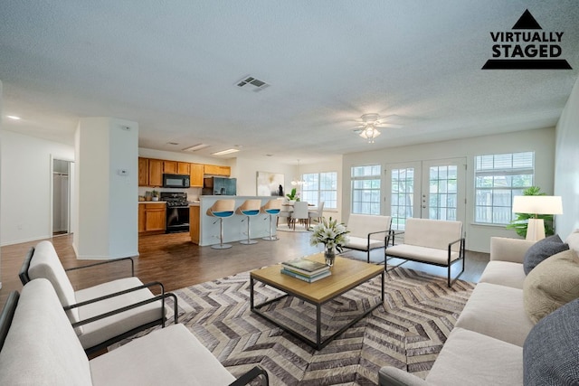 1911 Timberwood Dr, Cedar Park, TX 78613 - living area with plenty of natural light, ceiling fan, a textured ceiling, wood finished floors, and baseboards