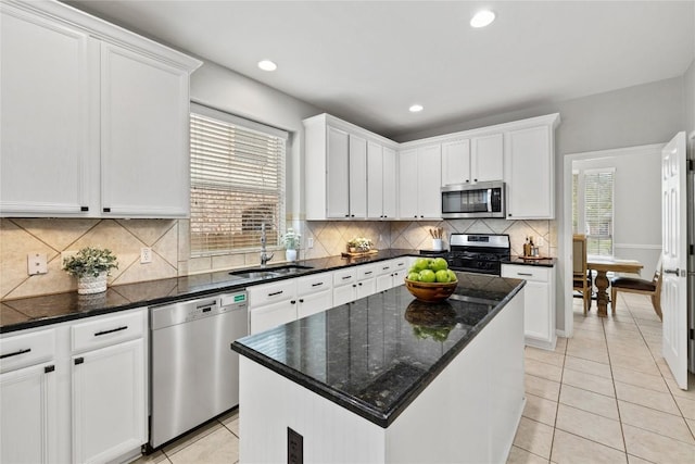kitchen featuring a sink, white cabinets, stainless steel appliances, and light tile patterned flooring