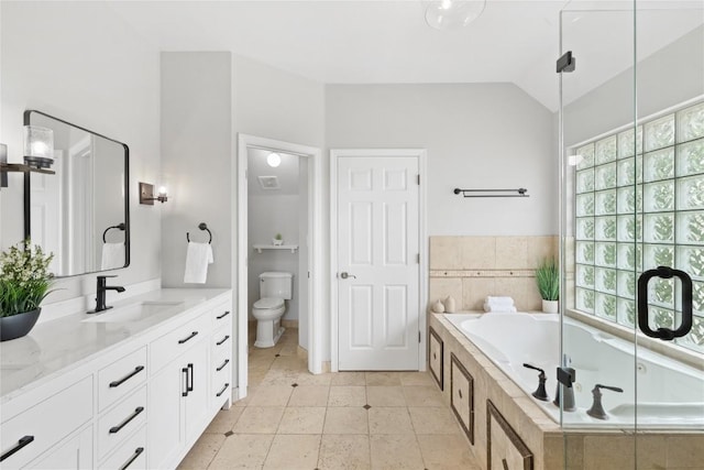 full bathroom with a garden tub, tile patterned flooring, double vanity, toilet, and a sink