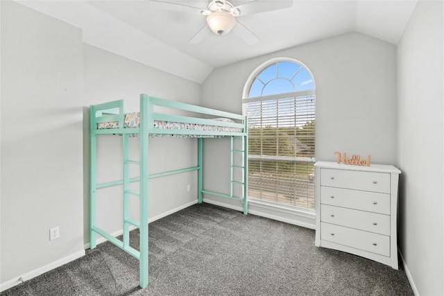 unfurnished bedroom featuring baseboards, a ceiling fan, carpet, and vaulted ceiling