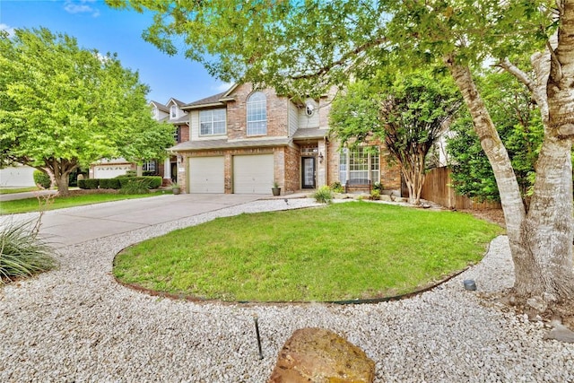 traditional-style house with brick siding, fence, a front lawn, concrete driveway, and an attached garage