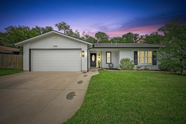 ranch-style home with driveway, a front yard, brick siding, fence, and an attached garage