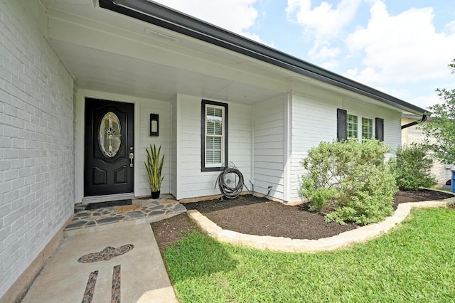 entrance to property with brick siding