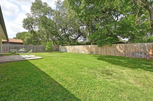 view of yard featuring a patio and a fenced backyard