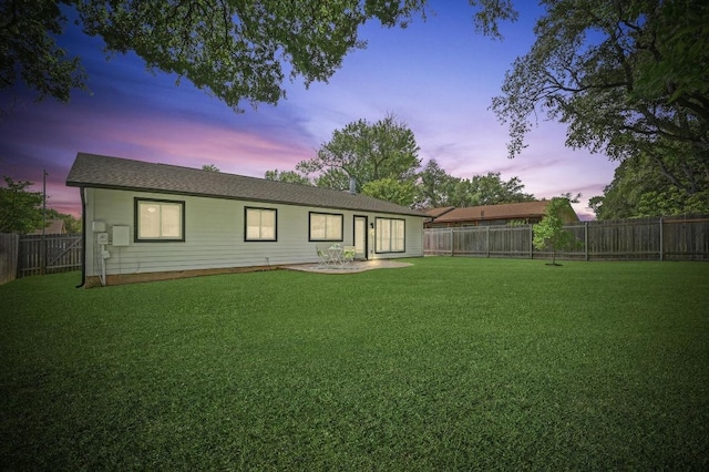 2406 Burly Oak Dr, Austin, TX 78745 - back of house at dusk with a lawn and a fenced backyard