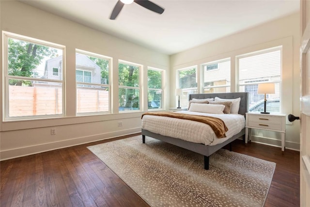 bedroom with baseboards, dark wood-style floors, and ceiling fan