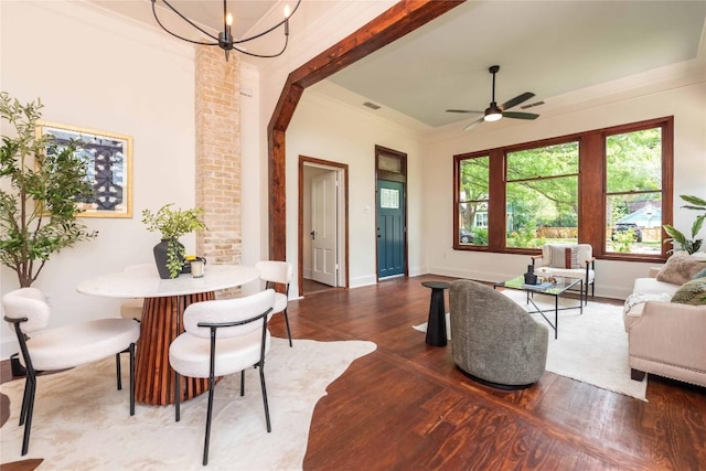 living room with arched walkways, baseboards, wood finished floors, and ceiling fan with notable chandelier