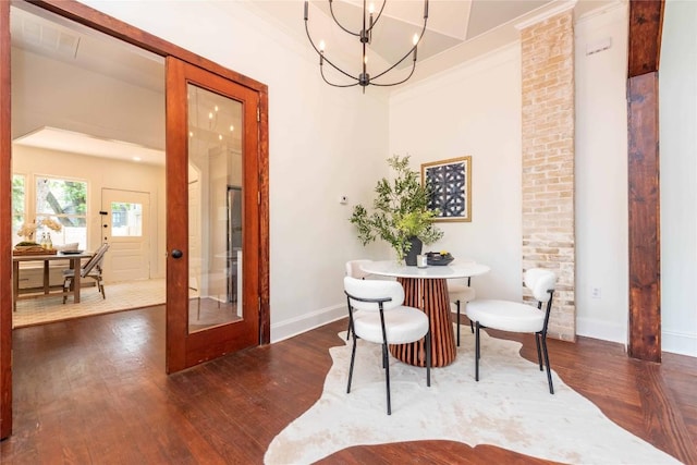 dining area with baseboards, a notable chandelier, french doors, and dark wood-type flooring