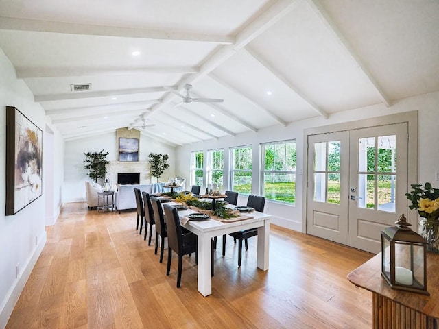 sunroom featuring french doors, visible vents, and beamed ceiling