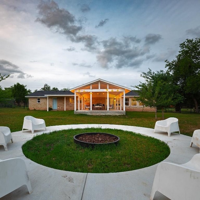 exterior space with a lawn, a patio, and fence