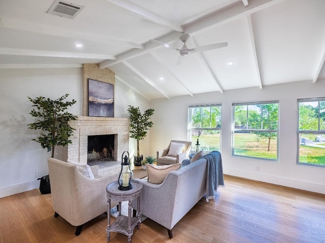 5203 Branding Chase St, Austin, TX 78727 - living room featuring ceiling fan, a brick fireplace, baseboards, wood finished floors, and visible vents