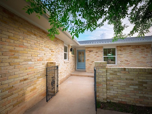 5203 Branding Chase St, Austin, TX 78727 - view of exterior entry with brick siding and a shingled roof