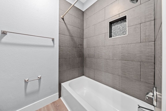1214 Vargas Rd Unit B, Austin, TX 78741 - bathroom with wood finished floors and shower / tub combination