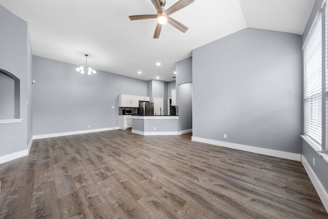 1214 Vargas Rd Unit B, Austin, TX 78741 - unfurnished living room featuring ceiling fan, a chandelier, plenty of natural light, dark wood finished floors, and lofted ceiling
