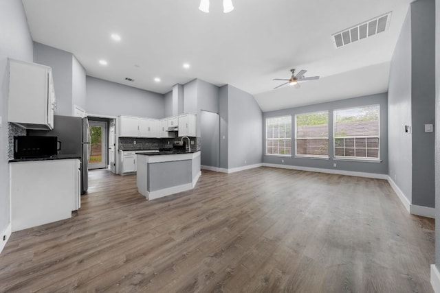 1214 Vargas Rd Unit B, Austin, TX 78741 - kitchen featuring open floor plan, lofted ceiling, dark countertops, a ceiling fan, and white cabinetry
