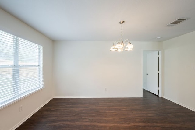 292 Dandelion Loop, Kyle, TX 78640 - spare room featuring a chandelier, dark wood-style flooring, and baseboards