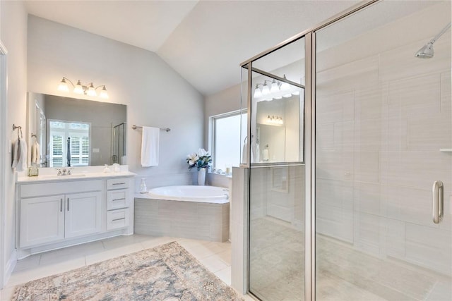 bathroom with a garden tub, a stall shower, vanity, tile patterned floors, and lofted ceiling
