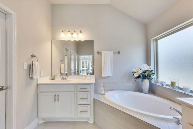 full bathroom featuring a bath, plenty of natural light, lofted ceiling, and vanity