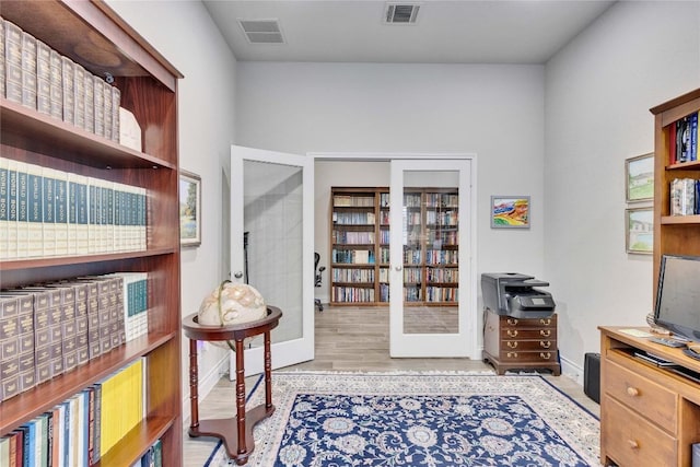 office featuring visible vents, baseboards, and wood finished floors