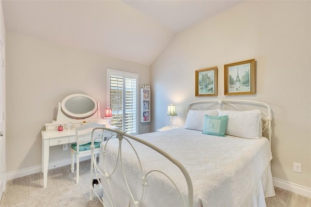 bedroom featuring baseboards, vaulted ceiling, and carpet floors