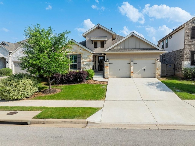 craftsman-style house featuring an attached garage, a front lawn, driveway, and stone siding