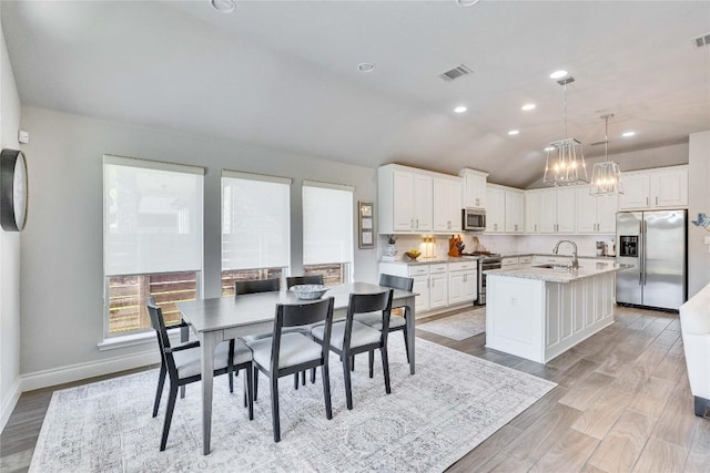 4229 Mercer Rd, Georgetown, TX 78628 - dining area with baseboards, light wood-type flooring, lofted ceiling, recessed lighting, and a chandelier