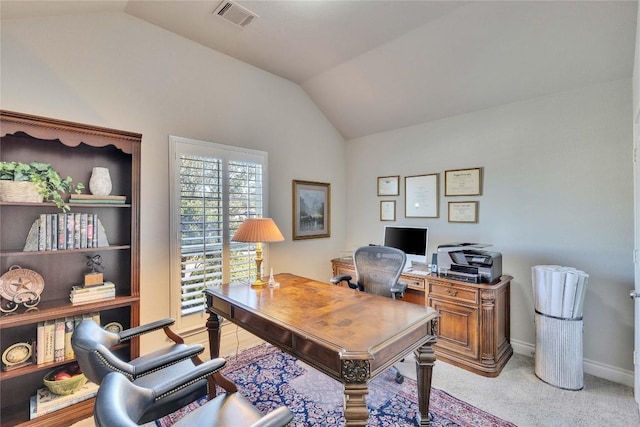 office featuring visible vents, baseboards, lofted ceiling, and light colored carpet