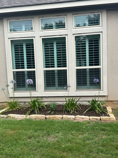 4229 Mercer Rd, Georgetown, TX 78628 - view of home's exterior with stucco siding, a shingled roof, and a yard