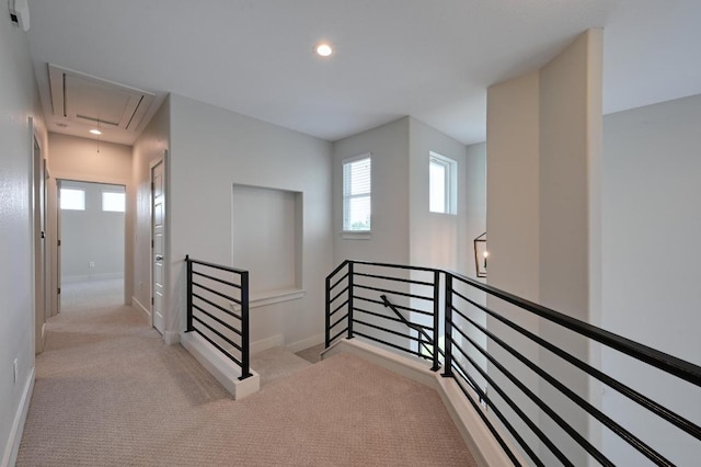 hallway featuring attic access, baseboards, an upstairs landing, carpet, and recessed lighting