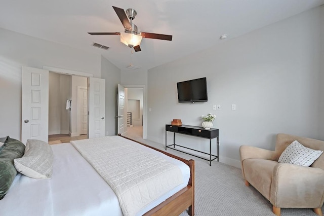 bedroom featuring visible vents, a ceiling fan, baseboards, and light colored carpet