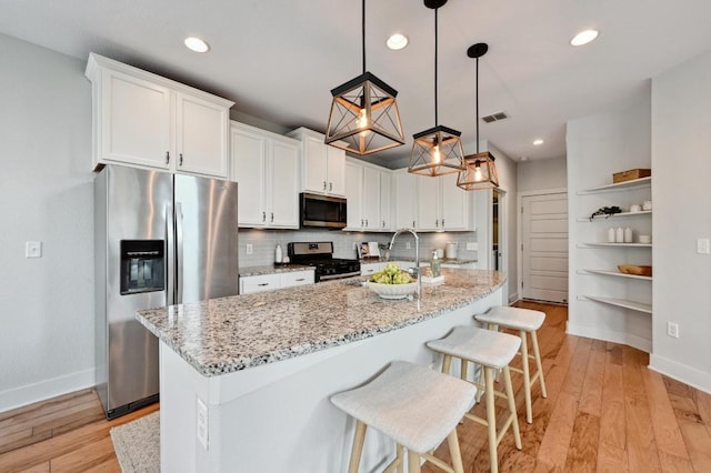 kitchen featuring baseboards, open shelves, stainless steel appliances, and visible vents