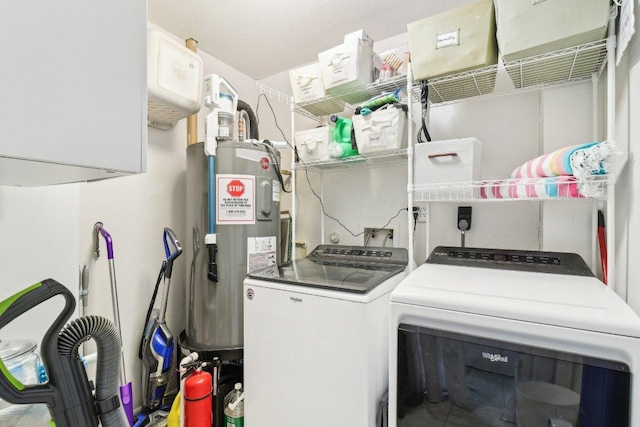421 James St, Boerne, TX 78006 - laundry room featuring washing machine and clothes dryer and electric water heater