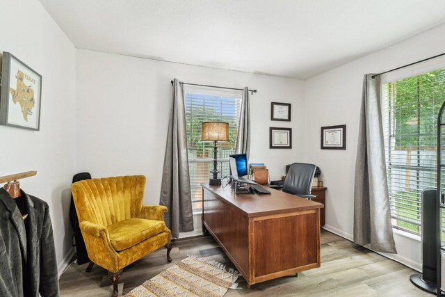office space with light wood-style floors and baseboards