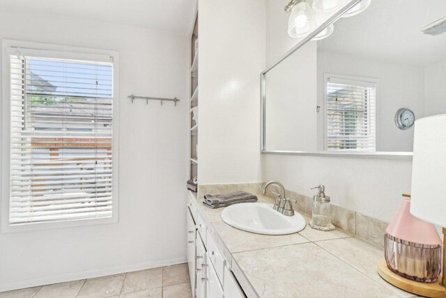 bathroom with vanity and baseboards