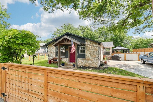view of outdoor structure with a fenced backyard and a gazebo