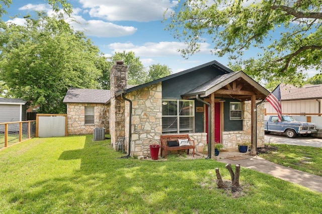 421 James St, Boerne, TX 78006 - view of front of house featuring stone siding, central AC unit, and a chimney
