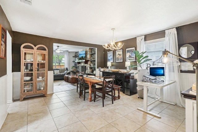 421 James St, Boerne, TX 78006 - dining area with wainscoting, a desk, a chandelier, light tile patterned floors, and a ceiling fan