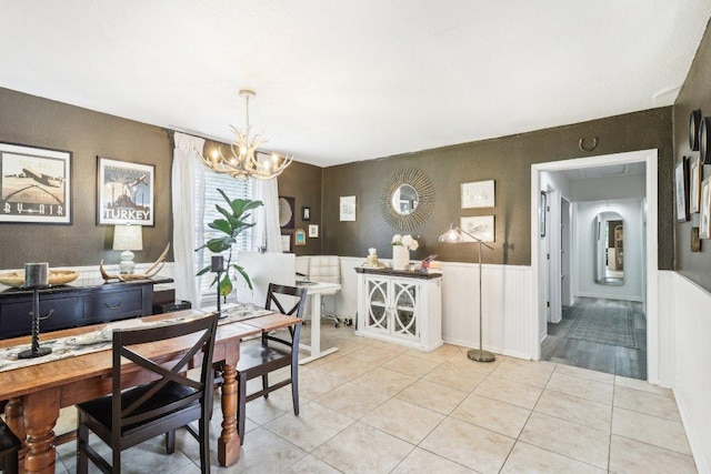 421 James St, Boerne, TX 78006 - dining room with a chandelier, wainscoting, and light tile patterned flooring