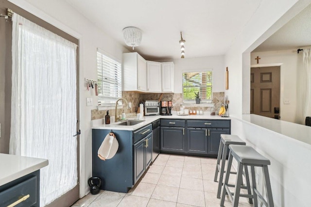 421 James St, Boerne, TX 78006 - kitchen featuring a sink, decorative backsplash, light countertops, and light tile patterned floors