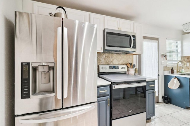 421 James St, Boerne, TX 78006 - kitchen with appliances with stainless steel finishes, a sink, decorative backsplash, light countertops, and light tile patterned floors