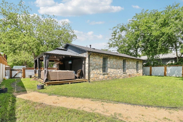 421 James St, Boerne, TX 78006 - rear view of property featuring stone siding, a gazebo, an outdoor hangout area, a gate, and board and batten siding